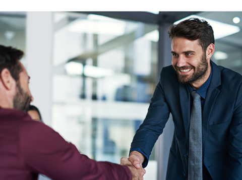 An image showing 2 colleagues shaking hands.